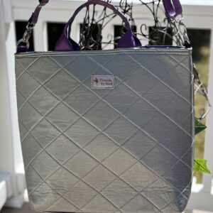 Handmade upcycled vinyl tote bag with purple African quilted fabric lining.