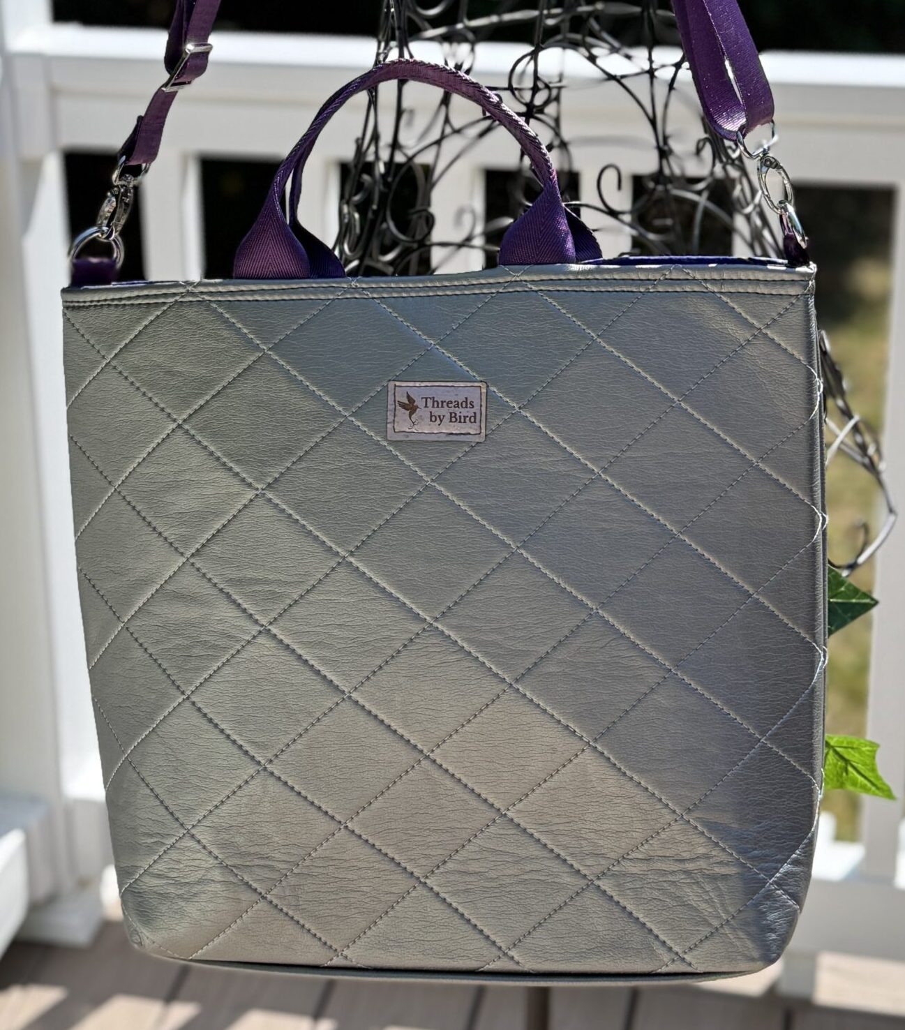 Handmade upcycled vinyl tote bag with purple African quilted fabric lining.